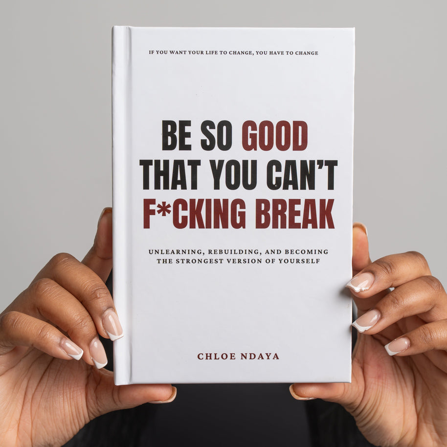 Book titled 'Be So Good That You Can't F*cking Break' held by a person against a gray background